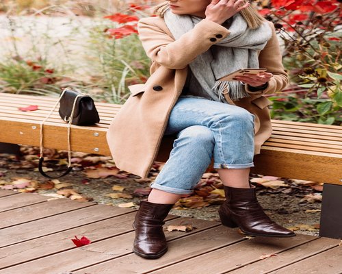 Comfortable daily footwear next to a bench in a serene autumn urban environment